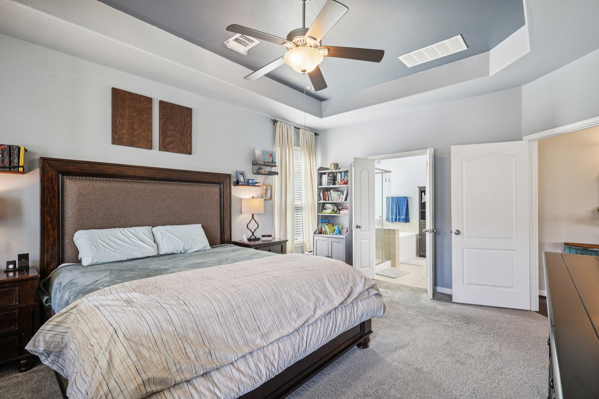 3663 Cottage Pines Lane Spring, TX 77386 - Photo 15 of 47 a bedroom with a large bed and a chandelier