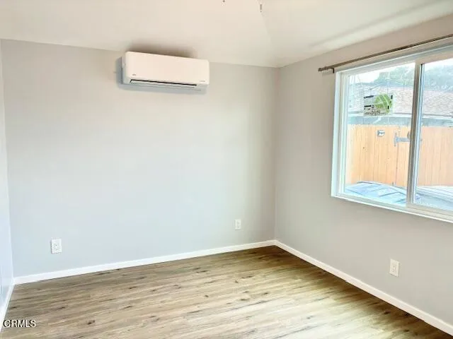 a view of a room with wooden floor and window