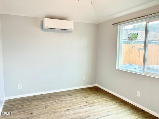 a view of a room with wooden floor and window