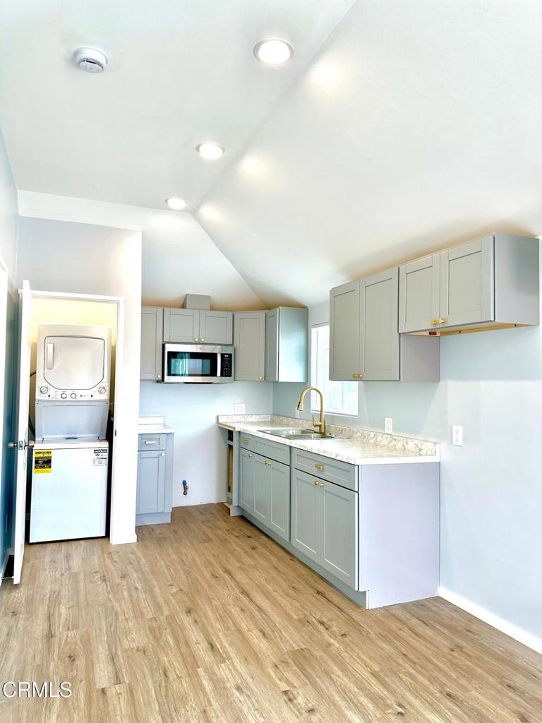 4614 Terrace Avenue, Unit JADU Oxnard, CA 93033 - Photo 13 of 16 a kitchen with a sink cabinets and wooden floor