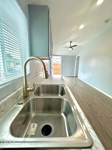 a kitchen with granite countertop cabinets sink and window