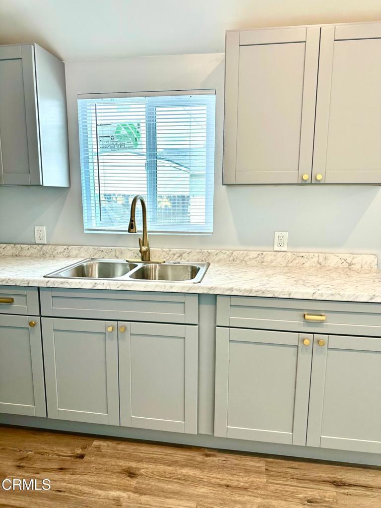 4614 Terrace Avenue, Unit JADU Oxnard, CA 93033 - Photo 16 of 16 a kitchen with granite countertop cabinets sink and window