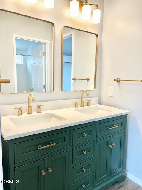 4614 Terrace Avenue, Unit JADU Oxnard, CA 93033 - Photo 4 of 16 a bathroom with a double vanity sink and a mirror