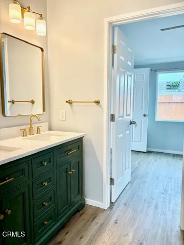 a spacious bathroom with a double vanity sink and mirror