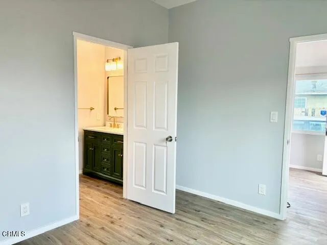 an empty room with wooden floor and closet