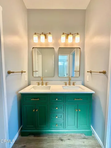 a bathroom with a double vanity sink and a mirror