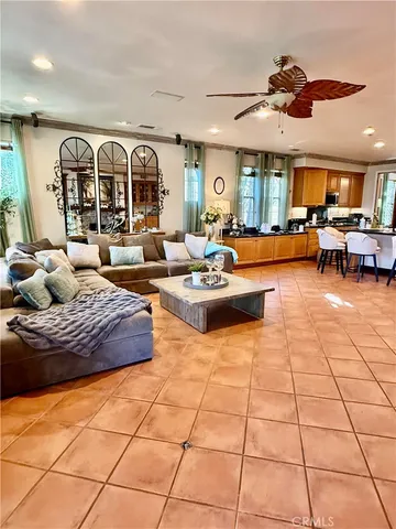 a living room with fireplace furniture and a large window