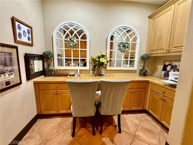 a dining hall with stainless steel appliances granite countertop a stove a sink dishwasher and a dining table with garden view