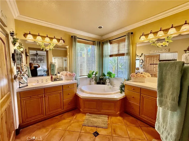 a bathroom with a tub sink and mirror