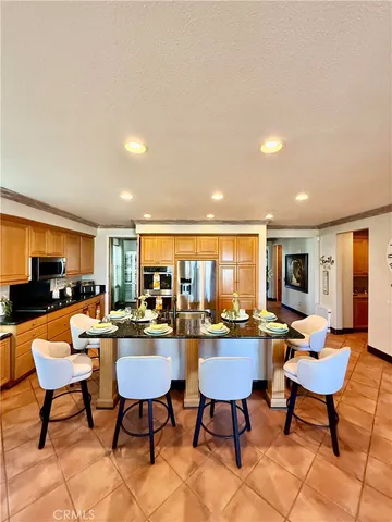 a living room with furniture a flat screen tv and a table