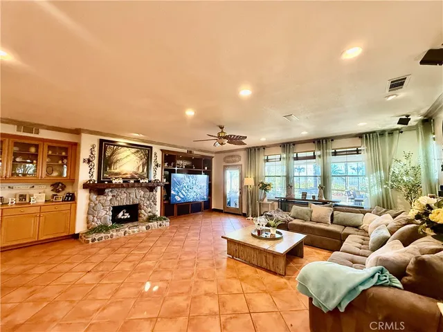 a living room with furniture large window and a flat screen tv