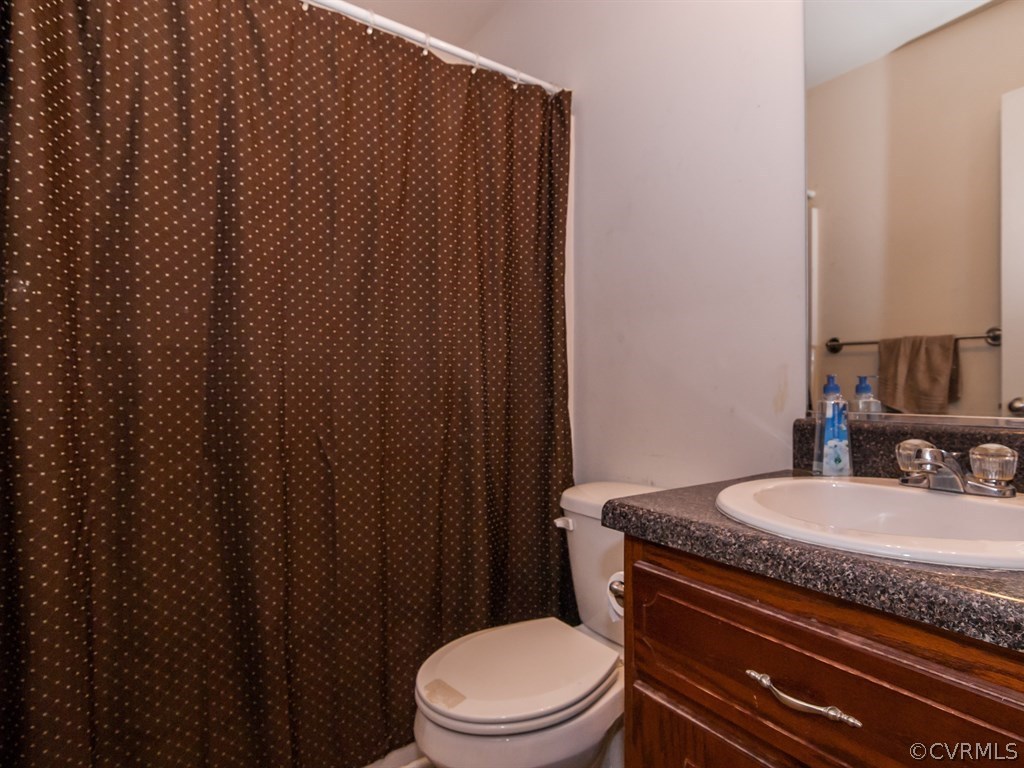 7311 Railroad Bed Road Carson, VA 23830 - Photo 18 of 23 a bathroom with a granite countertop toilet and sink
