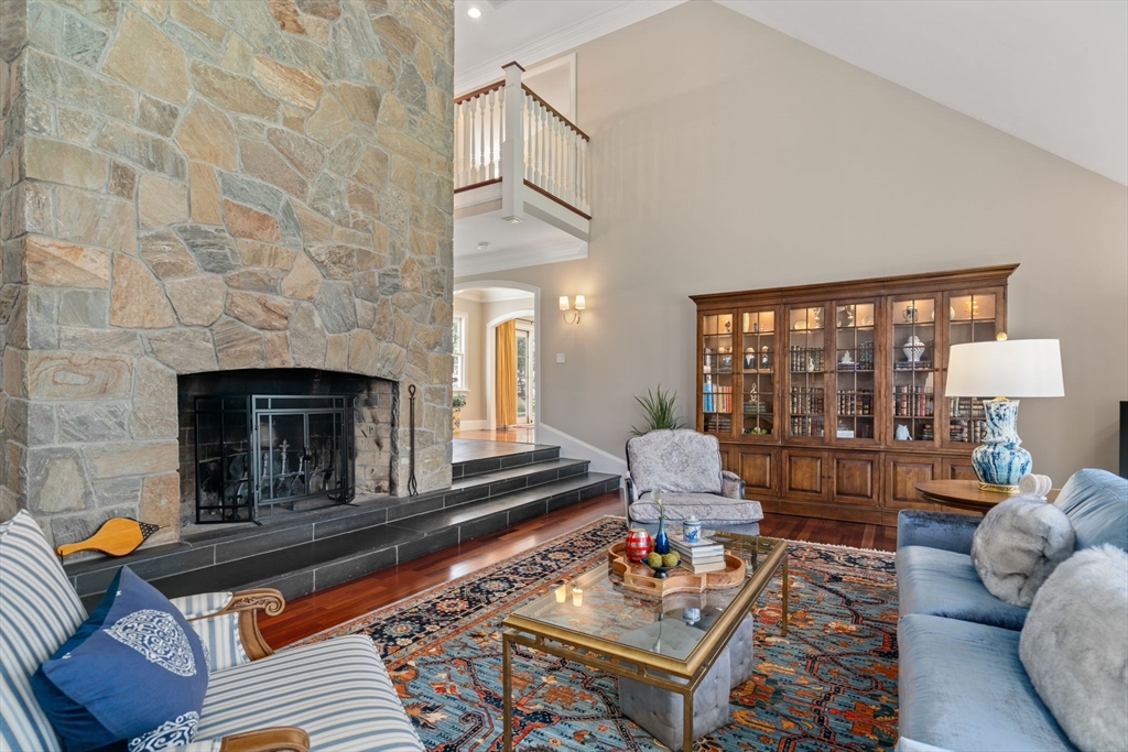 47 Brewster Road Sudbury, MA 01776 - Photo 16 of 41 a living room with furniture fireplace and a floor to ceiling window