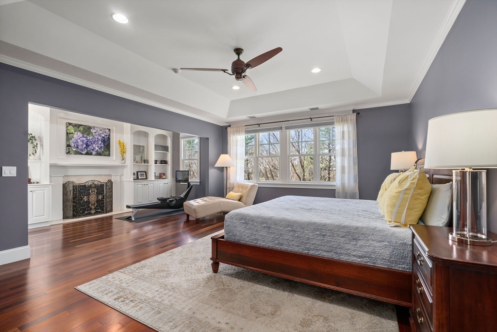 47 Brewster Road Sudbury, MA 01776 - Photo 20 of 41 a bedroom with a bed and wooden floor