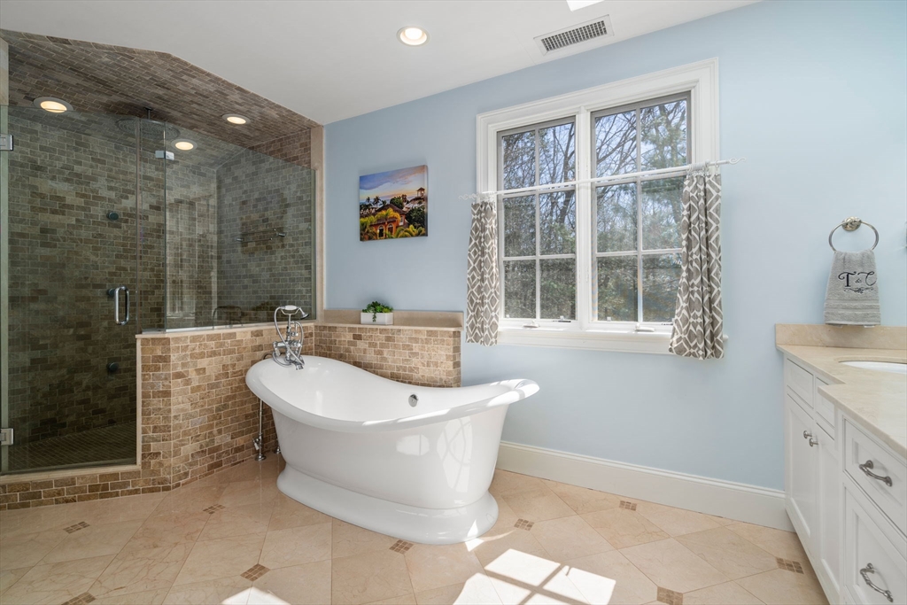 47 Brewster Road Sudbury, MA 01776 - Photo 23 of 41 a spacious bathroom with a bathtub and sink