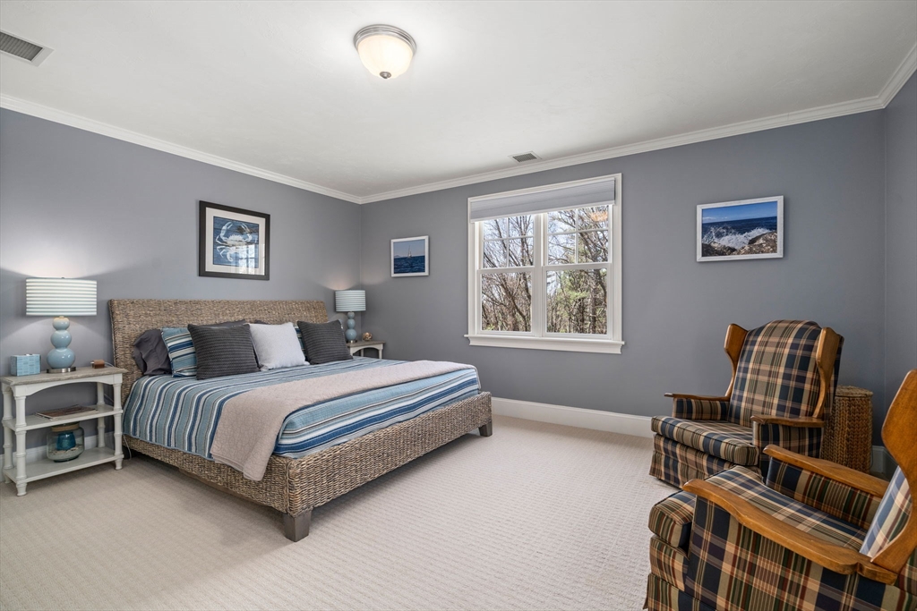 47 Brewster Road Sudbury, MA 01776 - Photo 24 of 41 a spacious bedroom with a bed and a chair