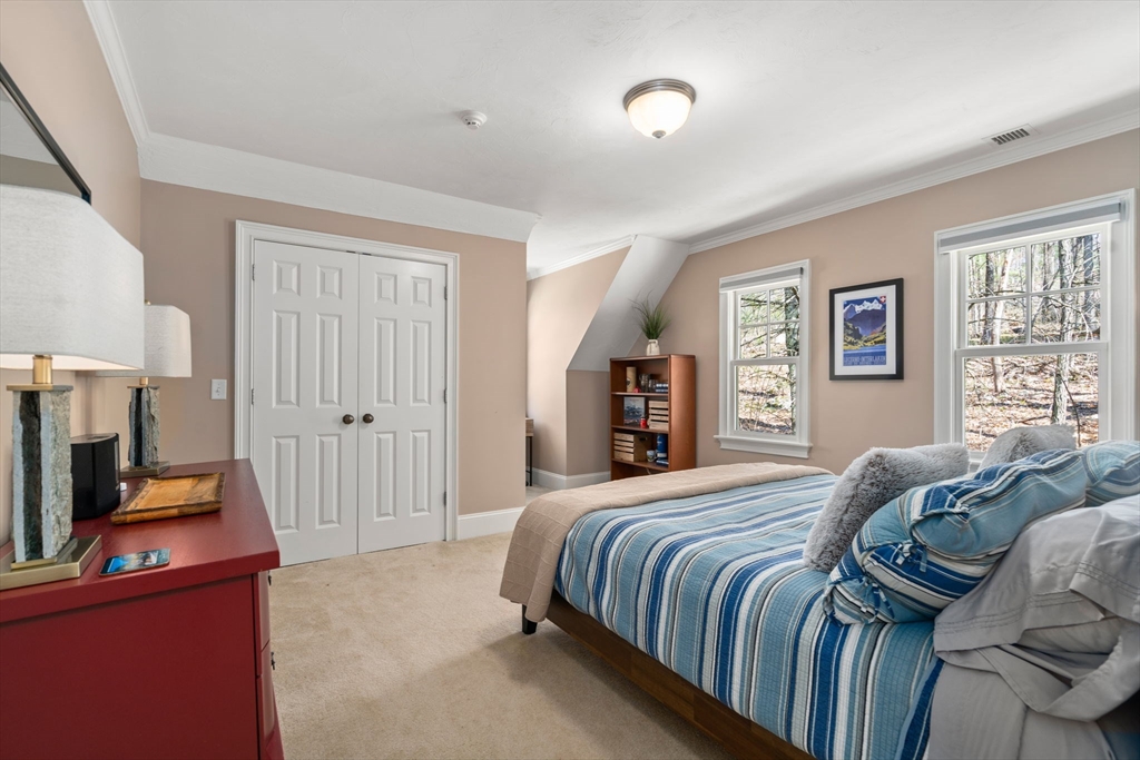 47 Brewster Road Sudbury, MA 01776 - Photo 27 of 41 a bedroom with a bed and a flat screen tv