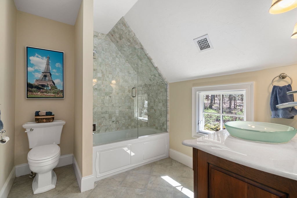 47 Brewster Road Sudbury, MA 01776 - Photo 28 of 41 a bathroom with a granite countertop toilet a sink and bathtub