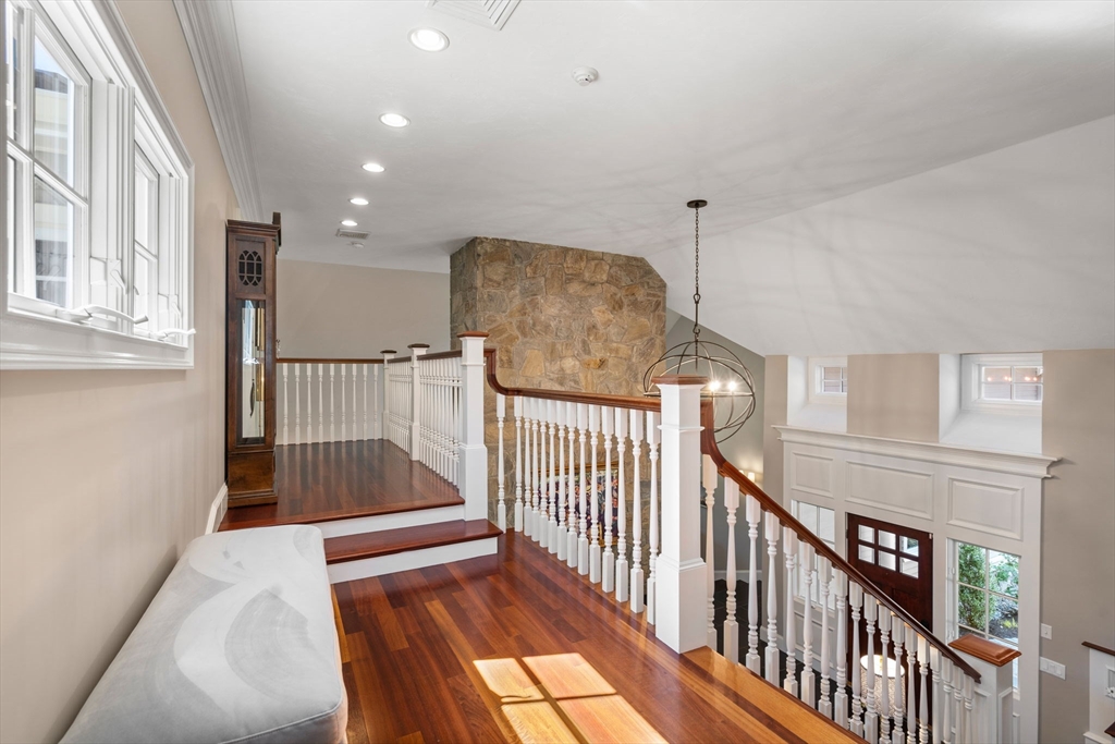 47 Brewster Road Sudbury, MA 01776 - Photo 29 of 41 a view of staircase with railing and a chandelier
