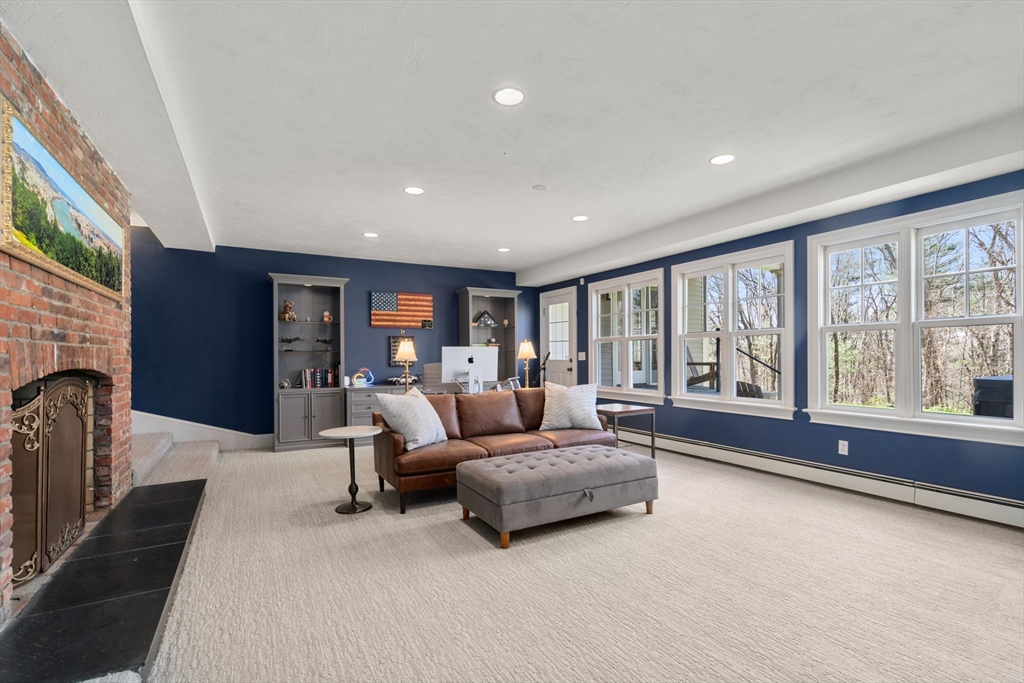 47 Brewster Road Sudbury, MA 01776 - Photo 30 of 41 a spacious bedroom with a large bed and a large window