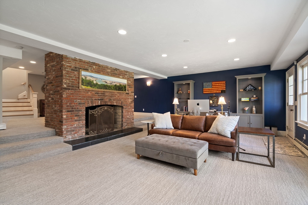 47 Brewster Road Sudbury, MA 01776 - Photo 31 of 41 a living room with furniture and a fireplace