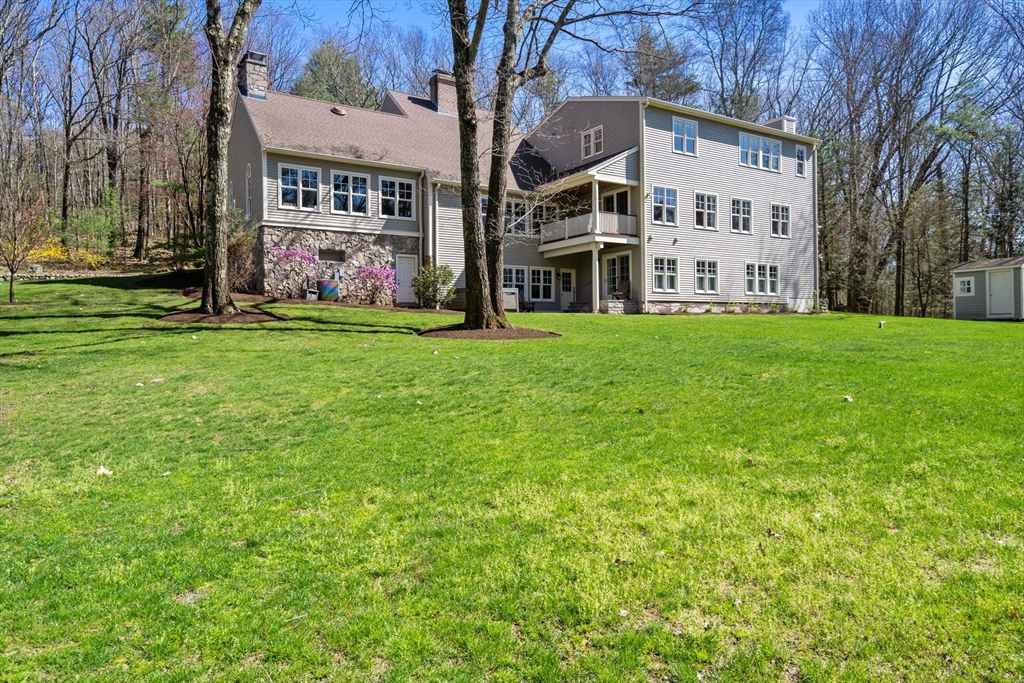 47 Brewster Road Sudbury, MA 01776 - Photo 36 of 41 a view of an apartment with a big yard and large trees