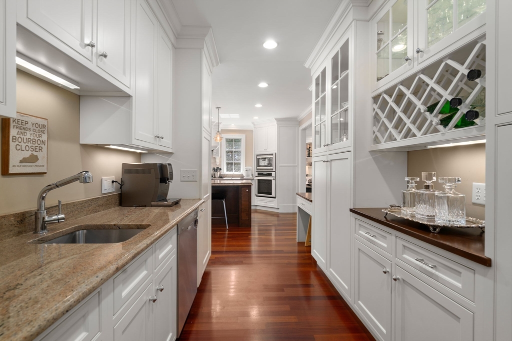 47 Brewster Road Sudbury, MA 01776 - Photo 7 of 41 a kitchen with stainless steel appliances granite countertop a sink a stove and a wooden floors