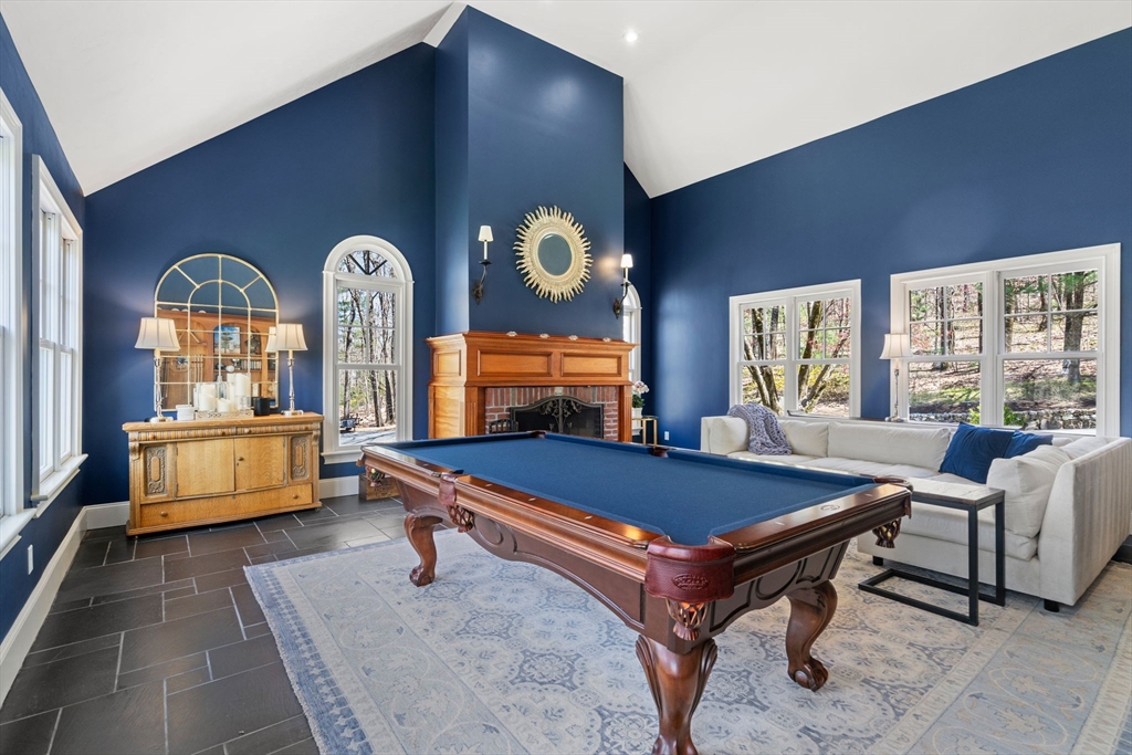 47 Brewster Road Sudbury, MA 01776 - Photo 10 of 41 a living room with furniture a chandelier and a large window