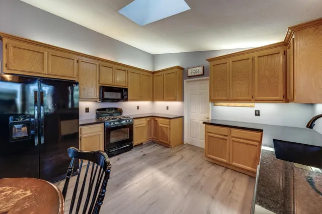 a kitchen with stainless steel appliances granite countertop a refrigerator stove microwave and sink