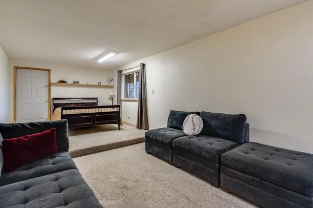a bedroom with a bed and a large window