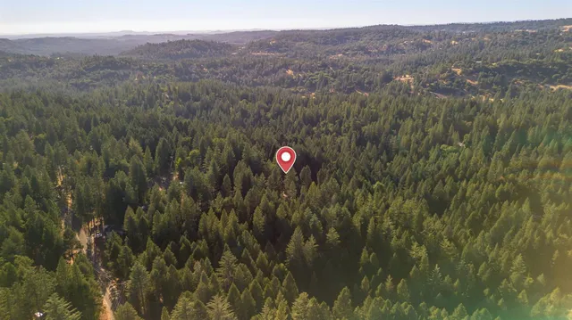 a view of a house with a yard and a garage