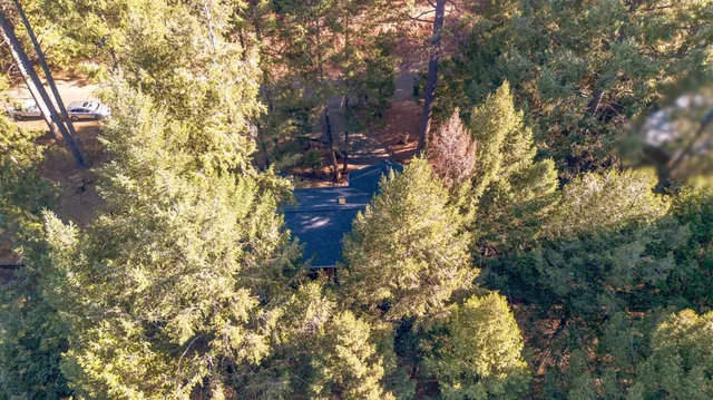 a dining hall with stainless steel appliances kitchen island a stove a table and chairs with wooden floor