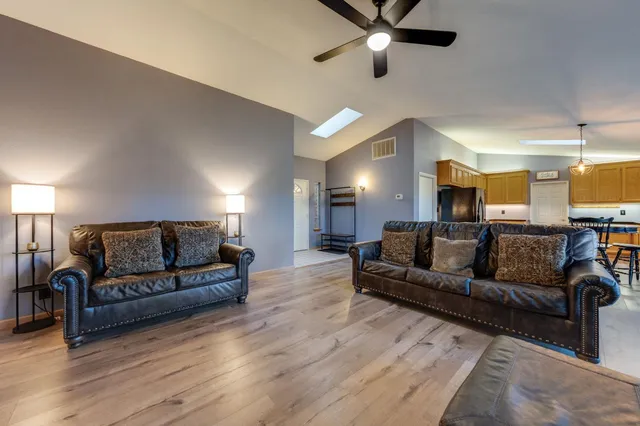 a living room with furniture and kitchen view