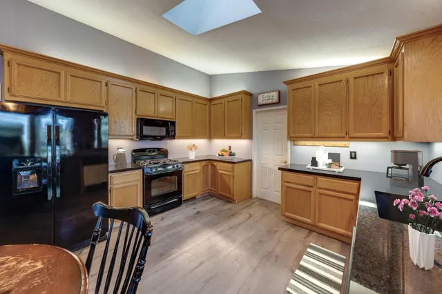 a kitchen with stainless steel appliances granite countertop a refrigerator stove microwave and sink