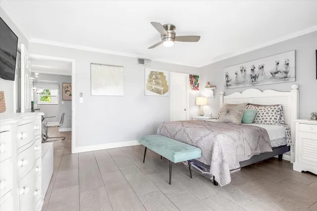 a spacious bedroom with a bed and a chandelier