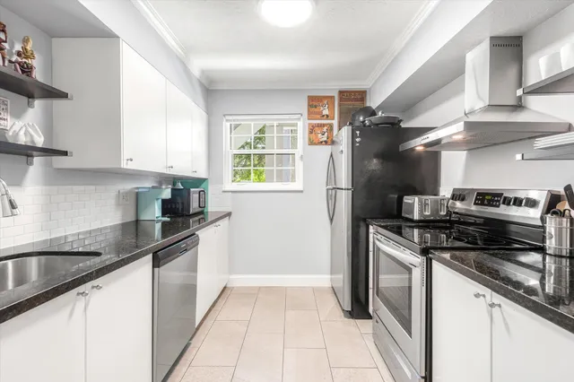 a kitchen with stainless steel appliances granite countertop a sink and a microwave
