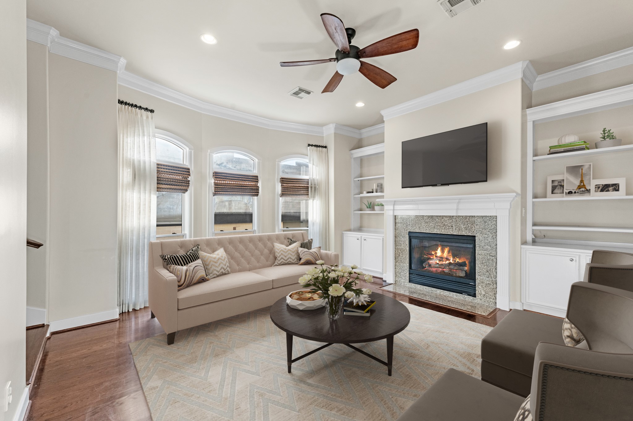5106 Crawford Street Houston, TX 77004 - Photo 18 of 37 a living room with furniture a fireplace and a flat screen tv
