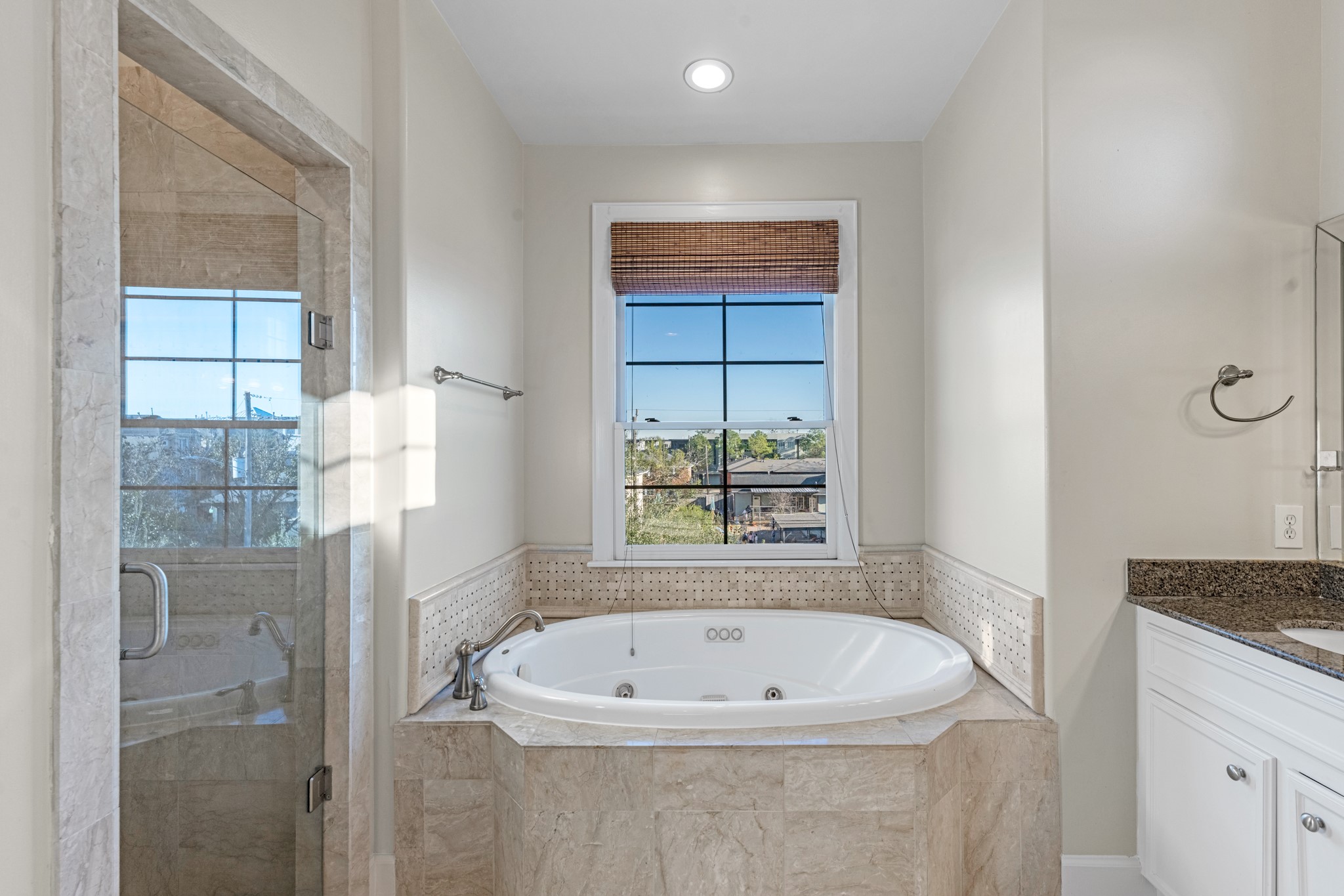 5106 Crawford Street Houston, TX 77004 - Photo 27 of 37 a bathroom with a granite countertop bathtub and window