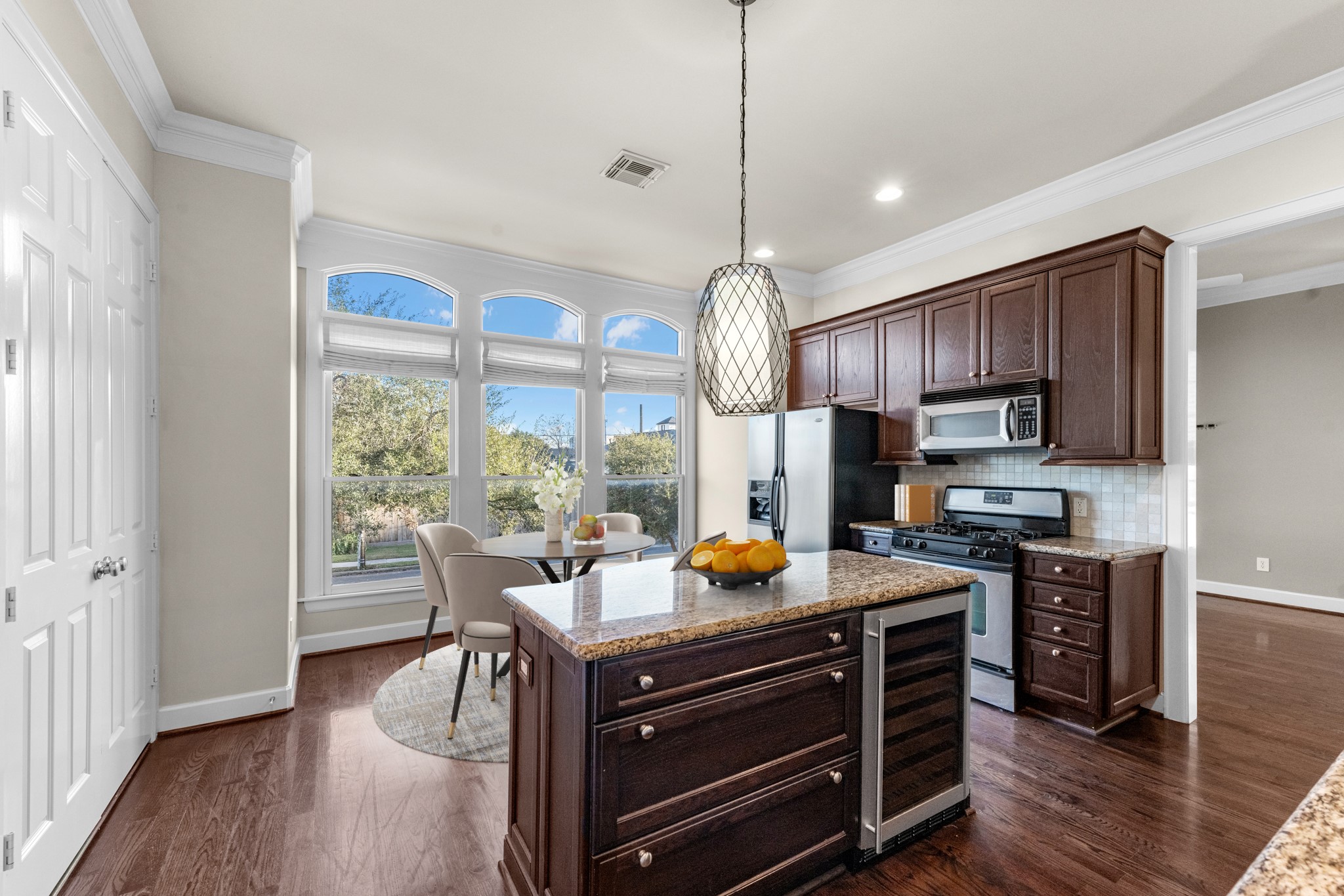 5106 Crawford Street Houston, TX 77004 - Photo 10 of 37 a kitchen that has a sink a stove and a wooden floor