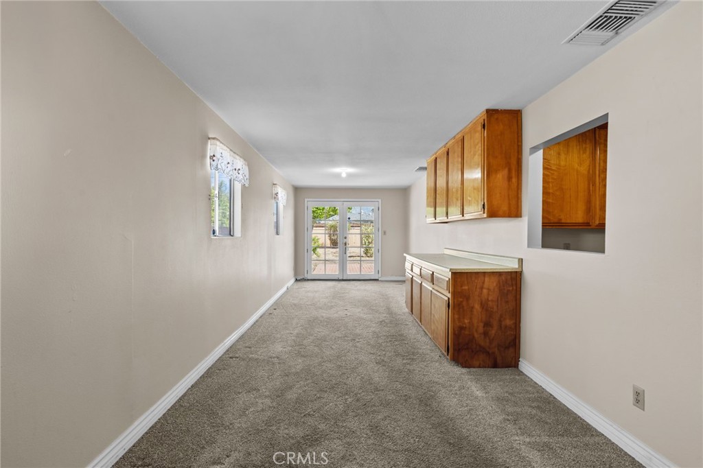 26652 7th Street Highland, CA 92346 - Photo 12 of 27 a view of an empty room with a fireplace and a window