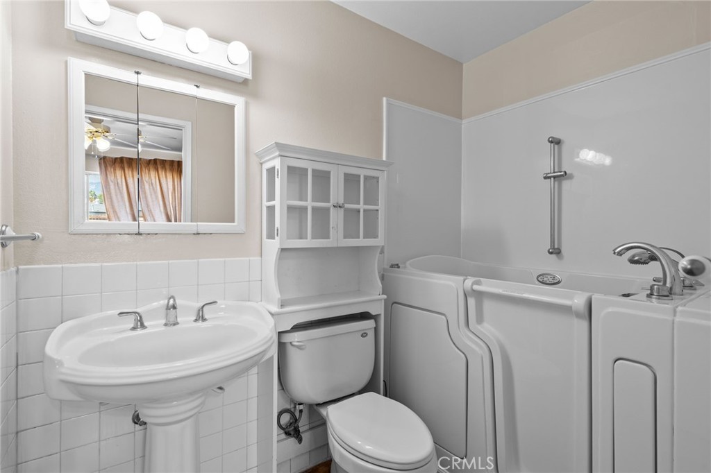 26652 7th Street Highland, CA 92346 - Photo 15 of 27 a bathroom with a sink a toilet and mirror