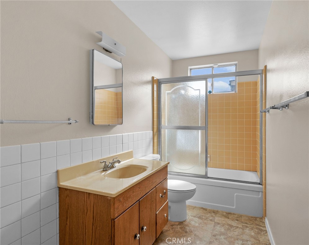 26652 7th Street Highland, CA 92346 - Photo 17 of 27 a bathroom with a sink toilet vanity and shower