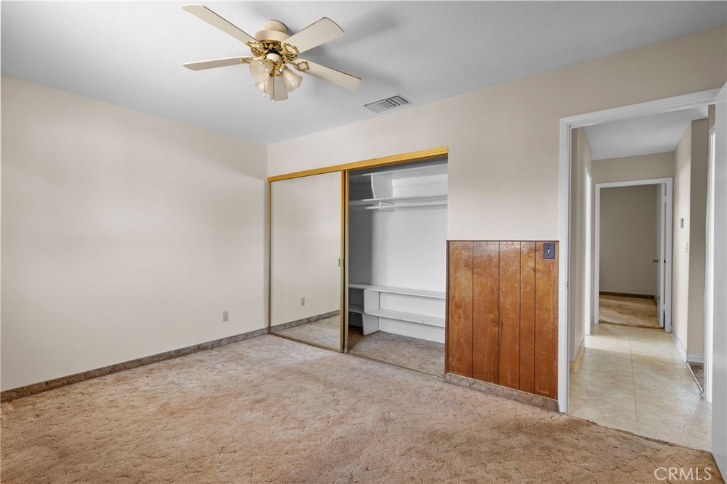 26652 7th Street Highland, CA 92346 - Photo 20 of 27 an empty room with closet and a chandelier fan