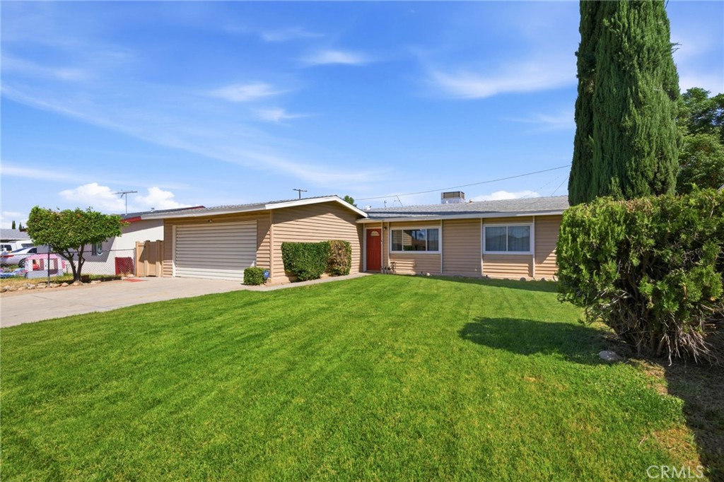 26652 7th Street Highland, CA 92346 - Photo 3 of 27 a front view of a house with a yard and trees