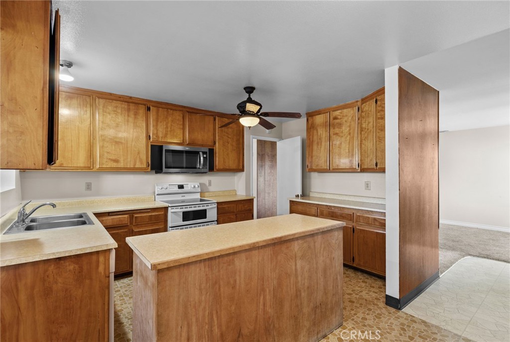 26652 7th Street Highland, CA 92346 - Photo 9 of 27 a kitchen with a sink a stove and cabinets