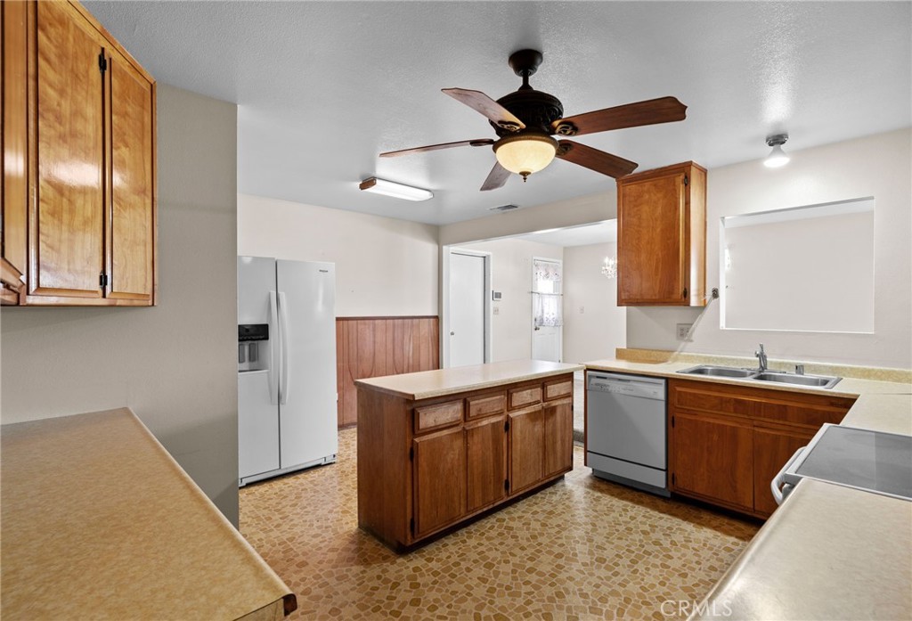 26652 7th Street Highland, CA 92346 - Photo 10 of 27 a kitchen with stainless steel appliances granite countertop a sink and a refrigerator