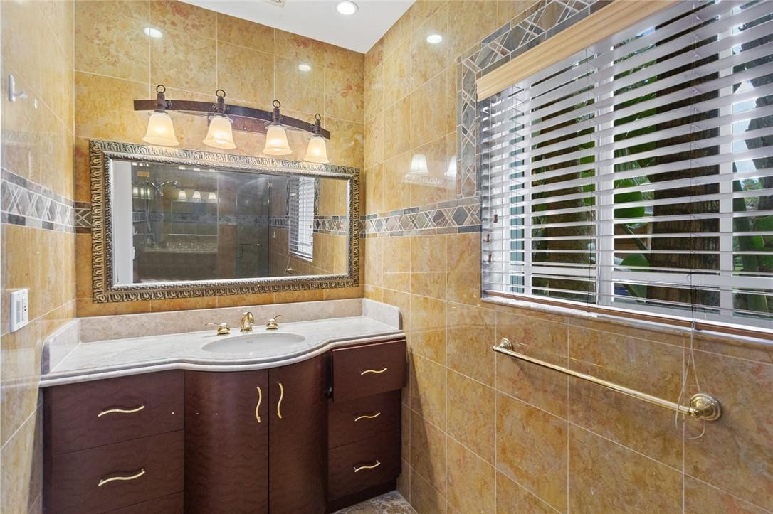6311 Melaleuca Road Southwest Ranches, FL 33330 - Photo 20 of 33 a bathroom with a sink a vanity and a mirror