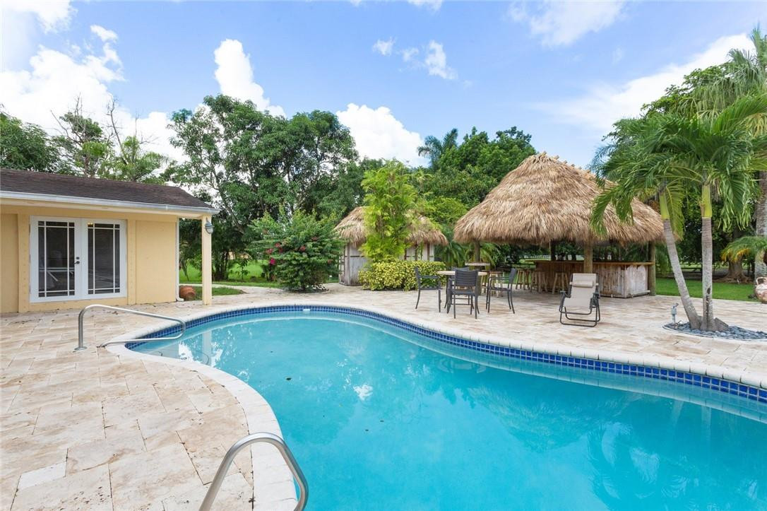 6311 Melaleuca Road Southwest Ranches, FL 33330 - Photo 27 of 33 a view of a house with pool and chairs
