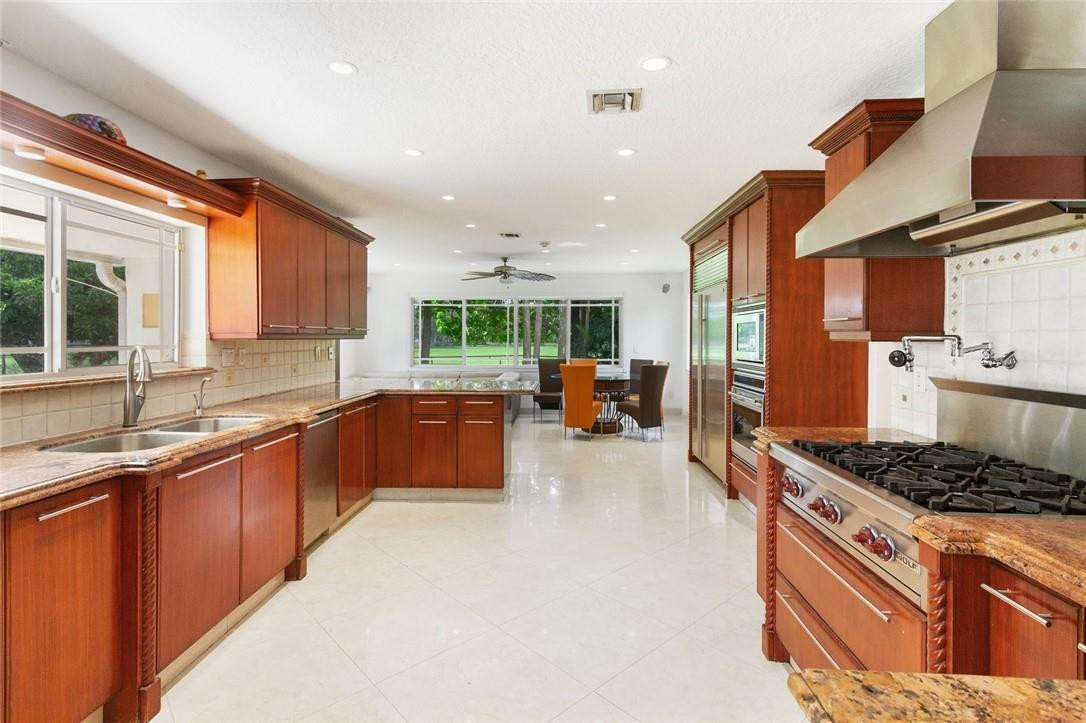 6311 Melaleuca Road Southwest Ranches, FL 33330 - Photo 5 of 33 a kitchen with stainless steel appliances granite countertop a stove a sink dishwasher and a refrigerator