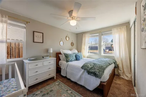 a bedroom with a large bed and a window